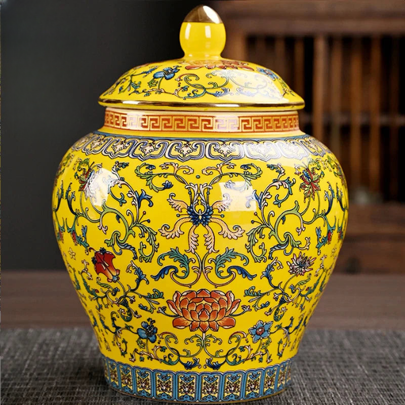 a yellow vase with a lid on a table