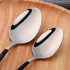 a couple of spoons sitting on top of a wooden tray