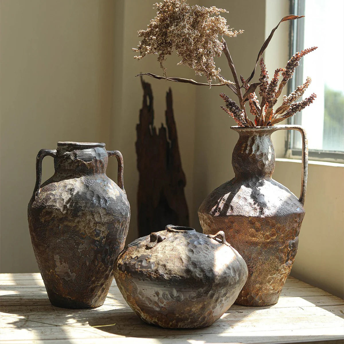 a couple of vases sitting on top of a table