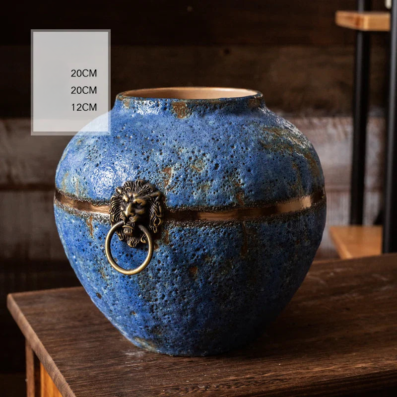 a blue vase sitting on top of a wooden table