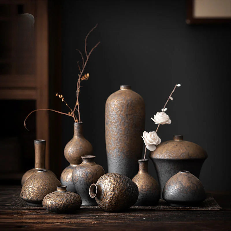 a group of vases sitting on top of a wooden table