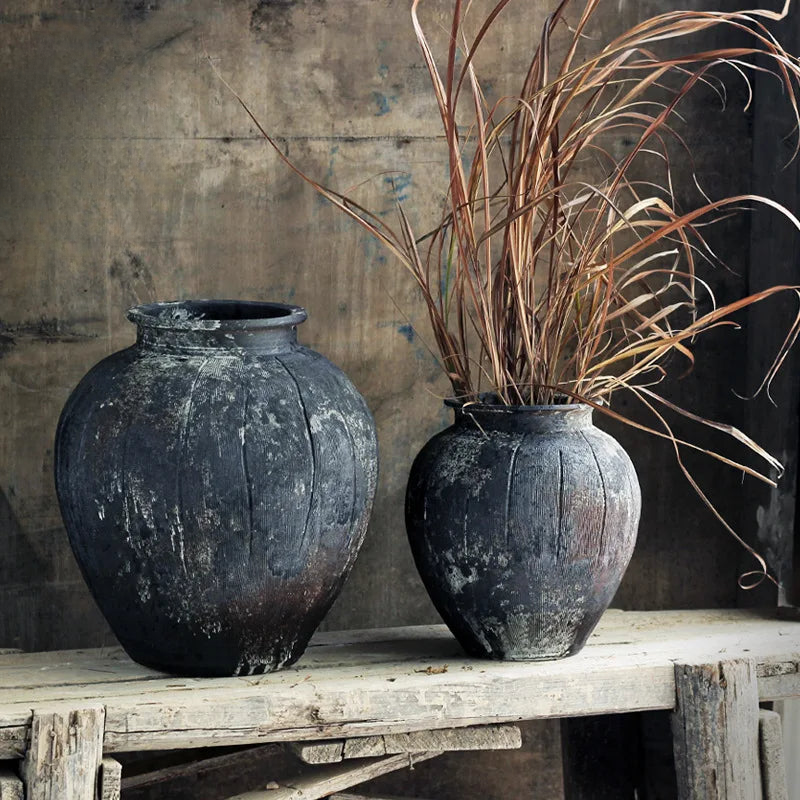 a couple of vases sitting on top of a wooden table