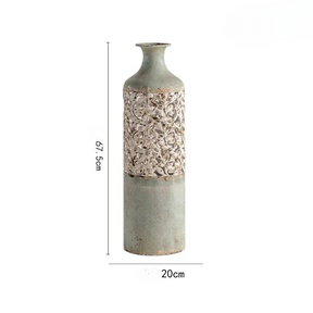 a tall vase with a flower pattern on it