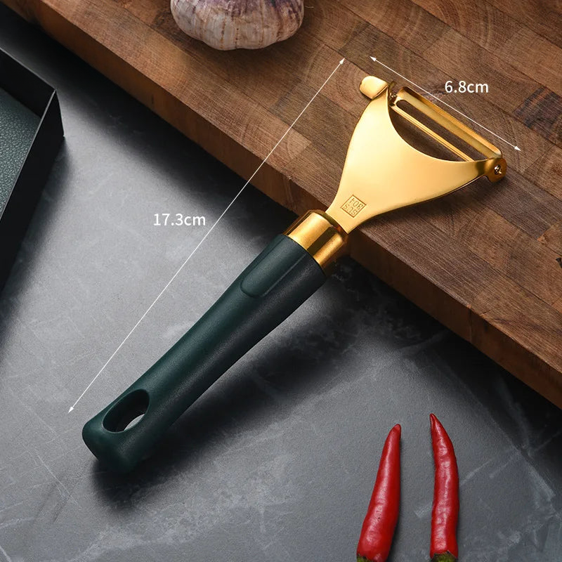 a gold and green vegetable grater on a wooden cutting board