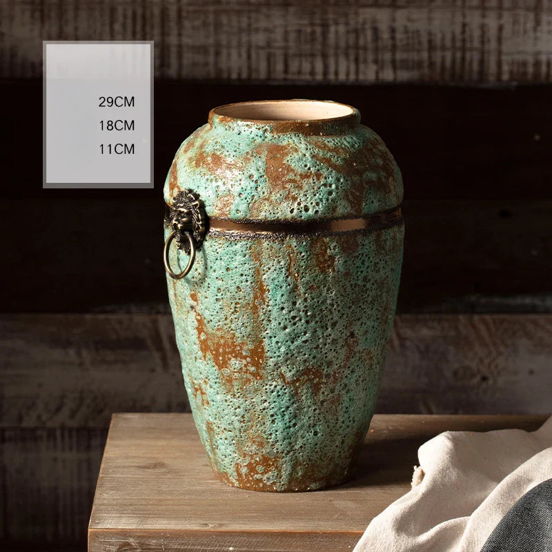 a large green vase sitting on top of a wooden table