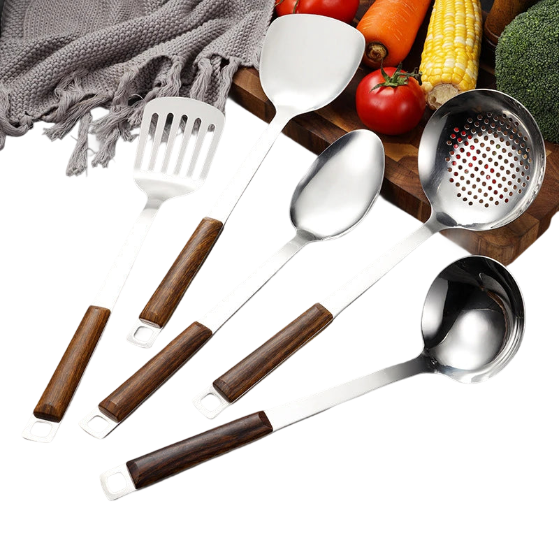 a set of five kitchen utensils sitting on top of a cutting board