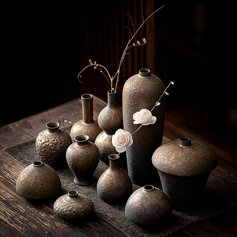 a group of vases sitting on top of a wooden table