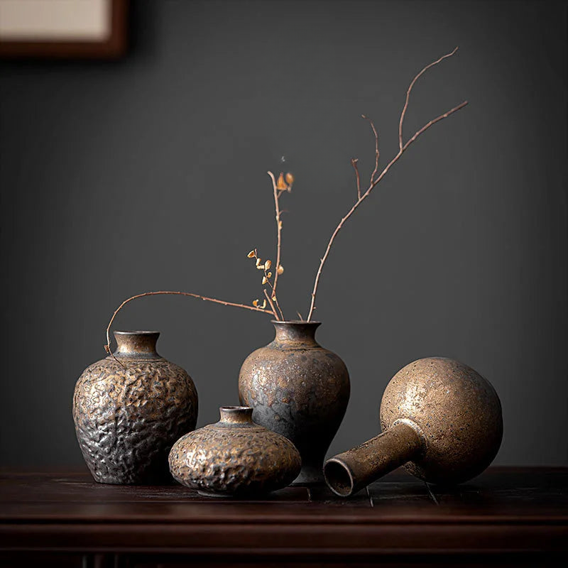 a group of vases sitting on top of a wooden table