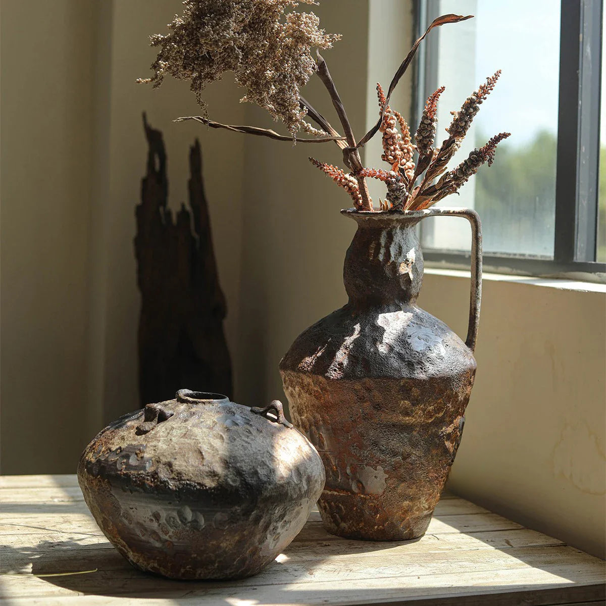 a couple of vases sitting on top of a wooden table