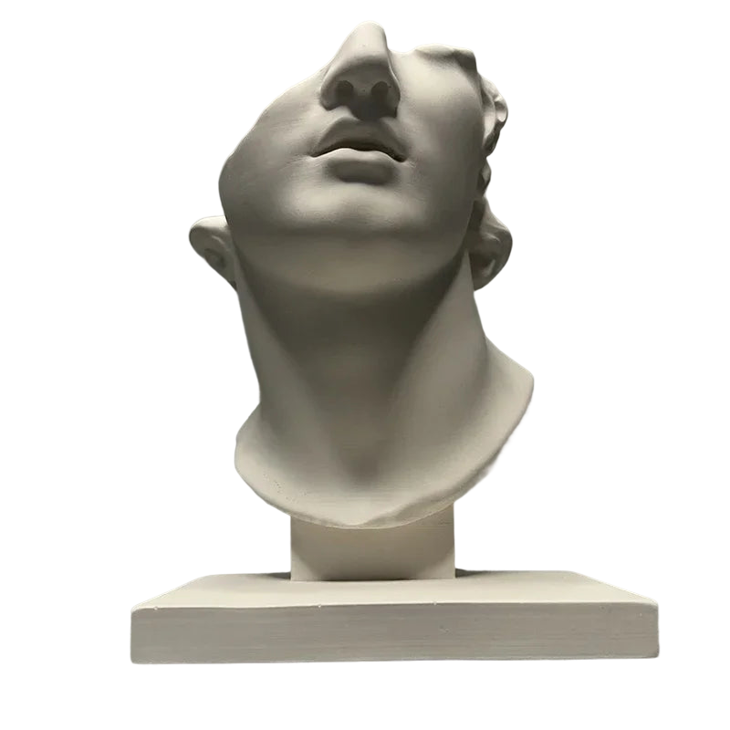 a white sculpture of a man's head with his eyes closed