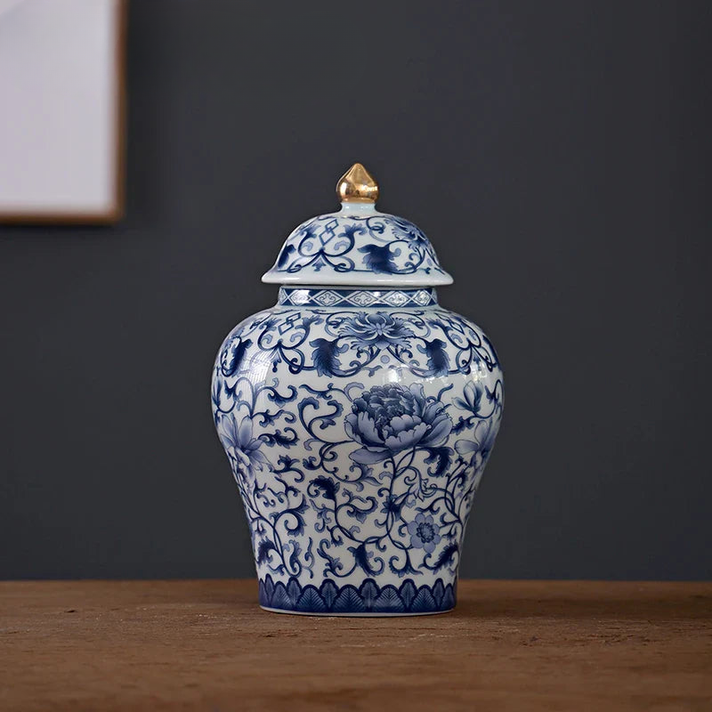 a blue and white vase sitting on top of a wooden table