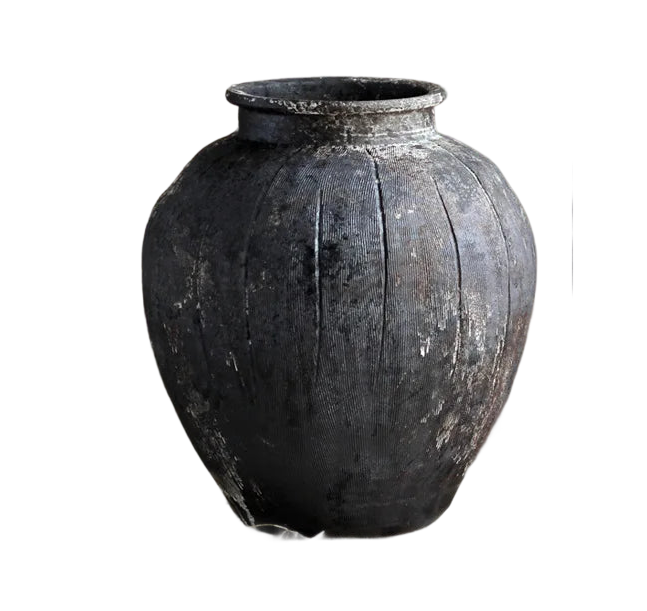 a large black vase sitting on top of a table