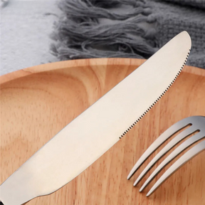 a knife and fork on a wooden plate