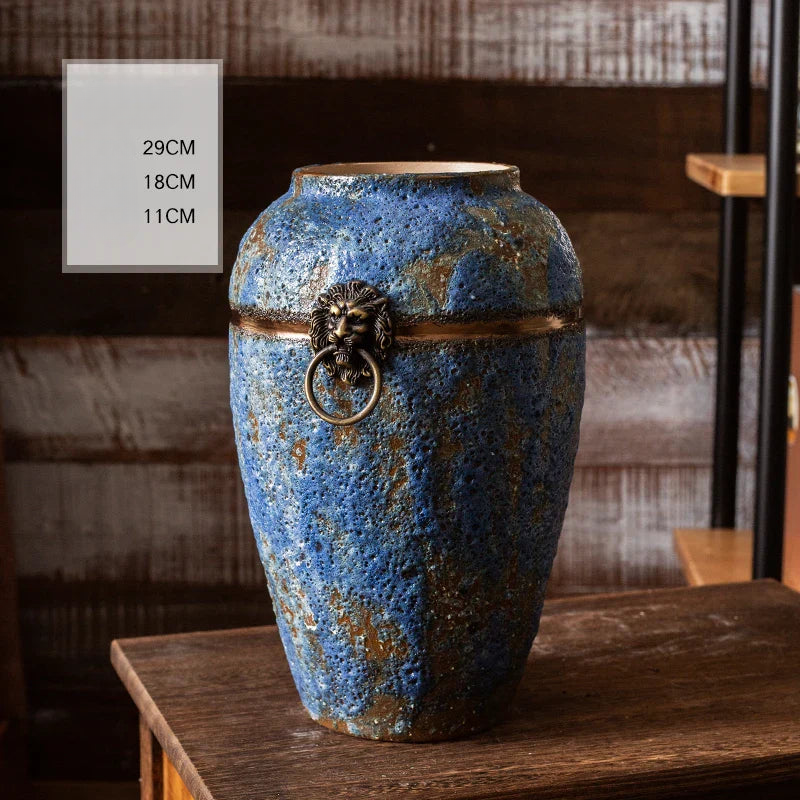 a blue vase sitting on top of a wooden table