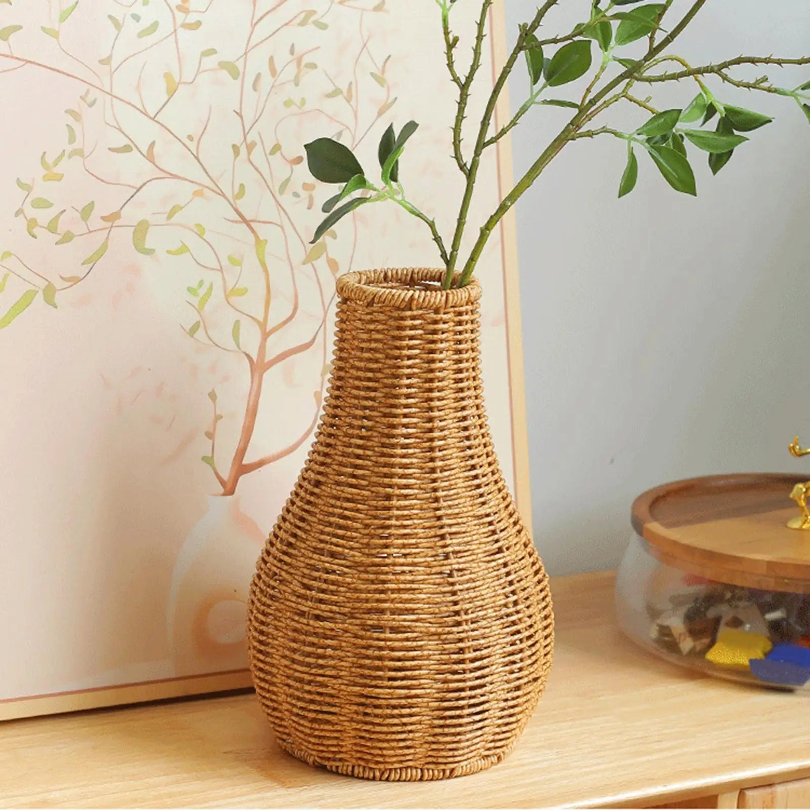 a wicker vase with a plant in it on a table