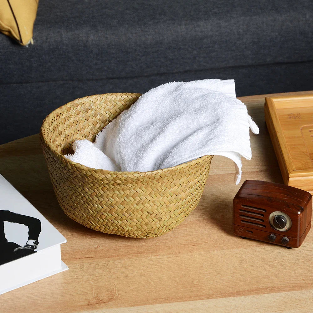 a wicker basket with a white towel in it