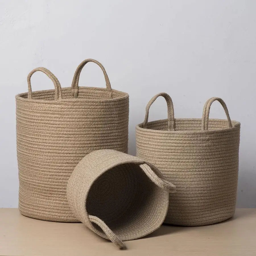 a set of three baskets sitting on top of a table