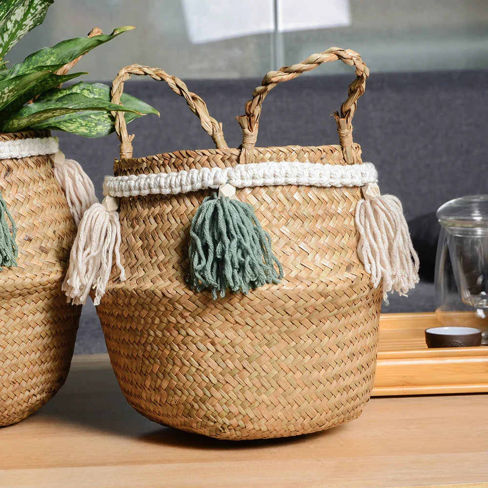 two woven baskets with tassels and a potted plant