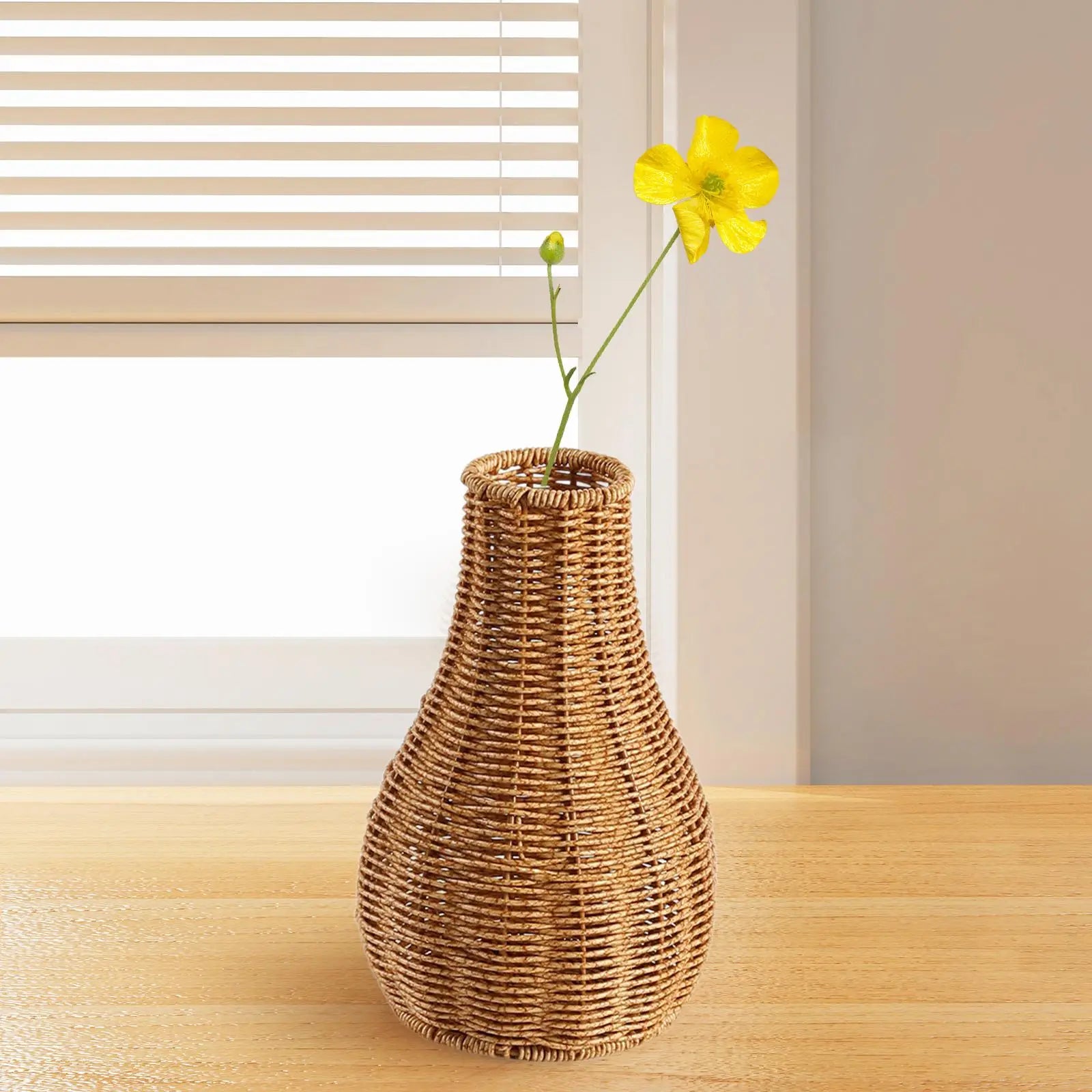 a wicker vase with a yellow flower in it