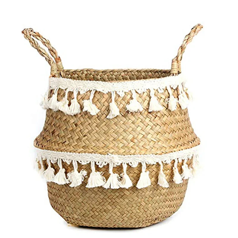 a woven basket with tassels and a handle