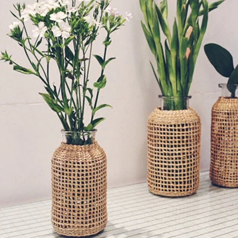 three vases with flowers in them sitting on a table