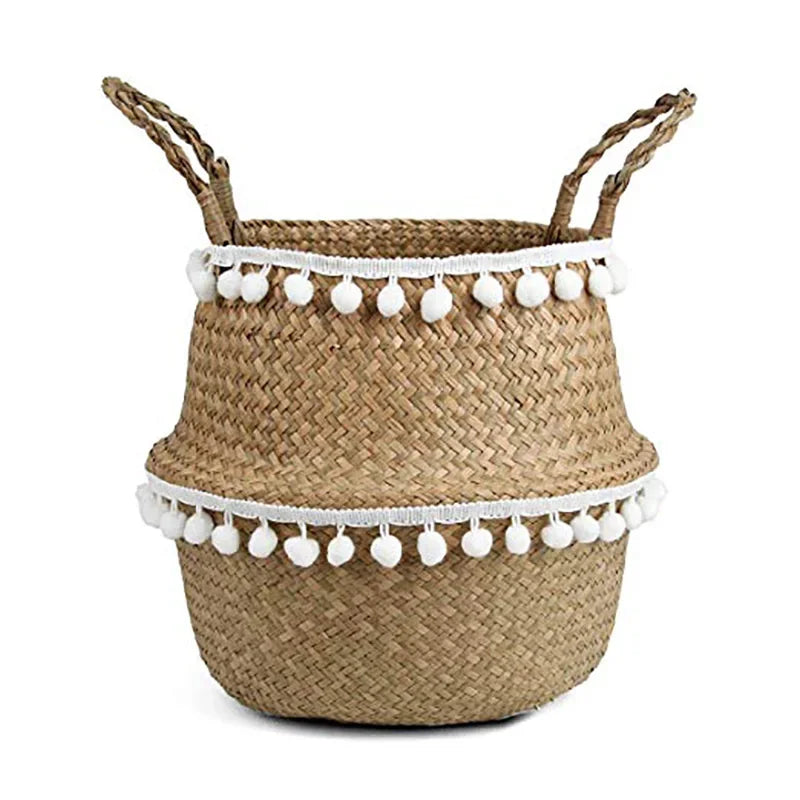 a basket with white pom poms on it