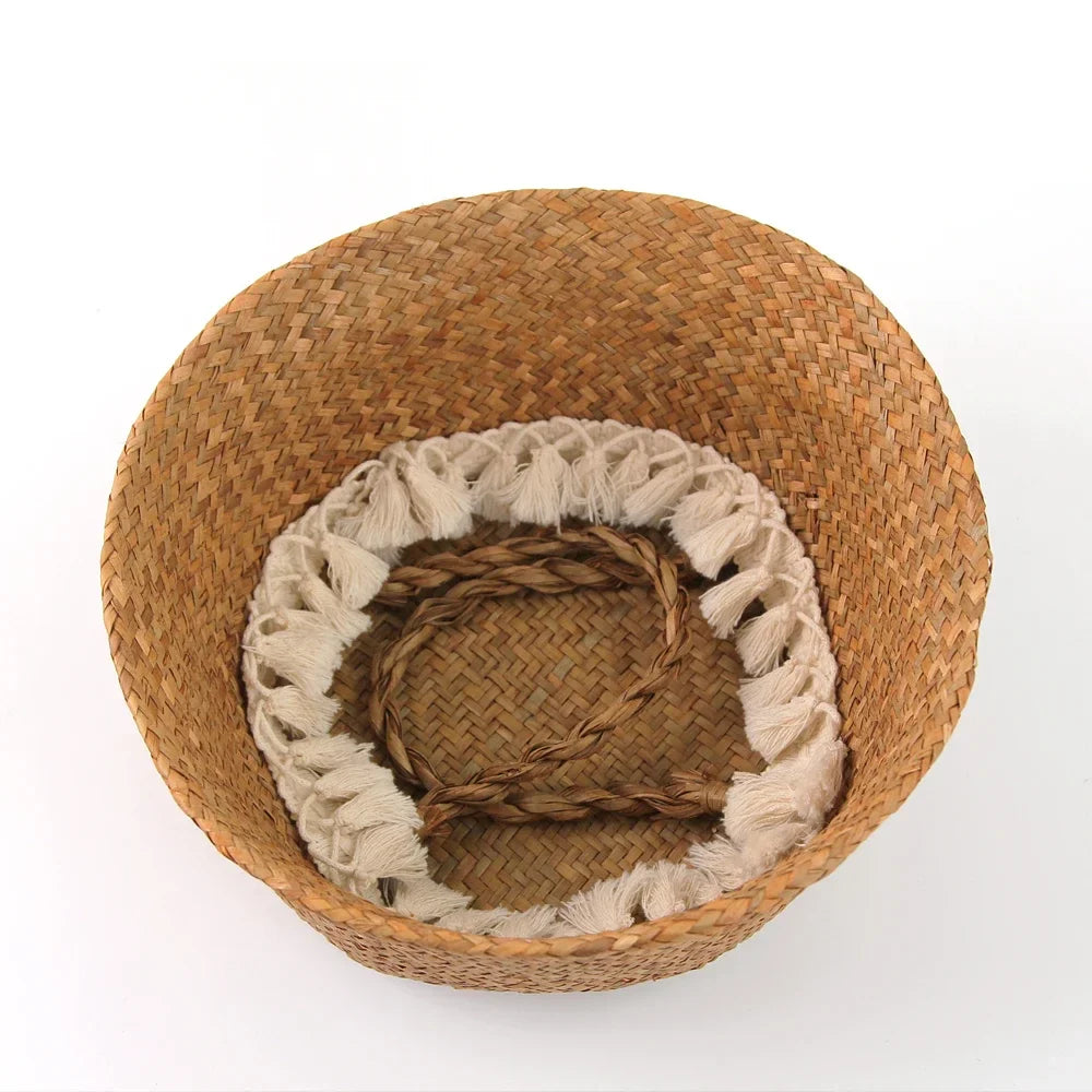 a brown basket with a white and beige blanket inside of it