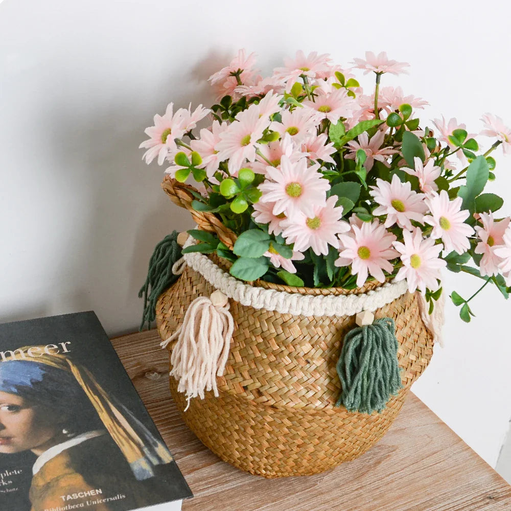 a basket filled with pink flowers next to a book