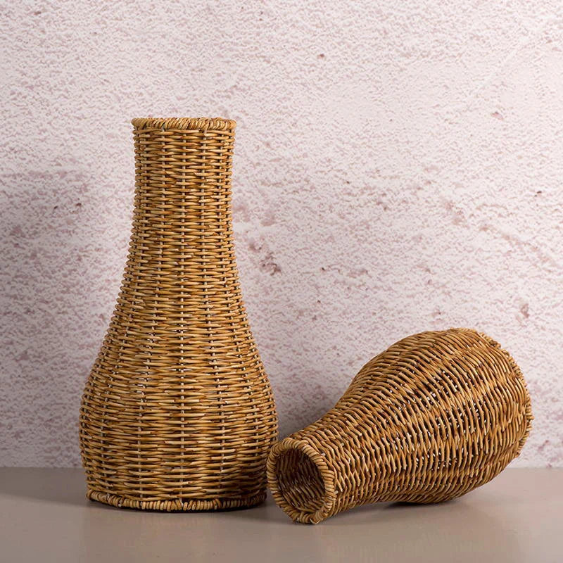 a wicker vase sitting next to a smaller wicker vase