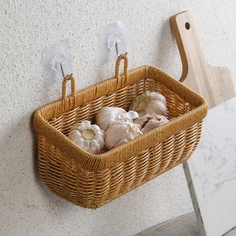 a wicker basket hanging on a wall with garlic cloves in it