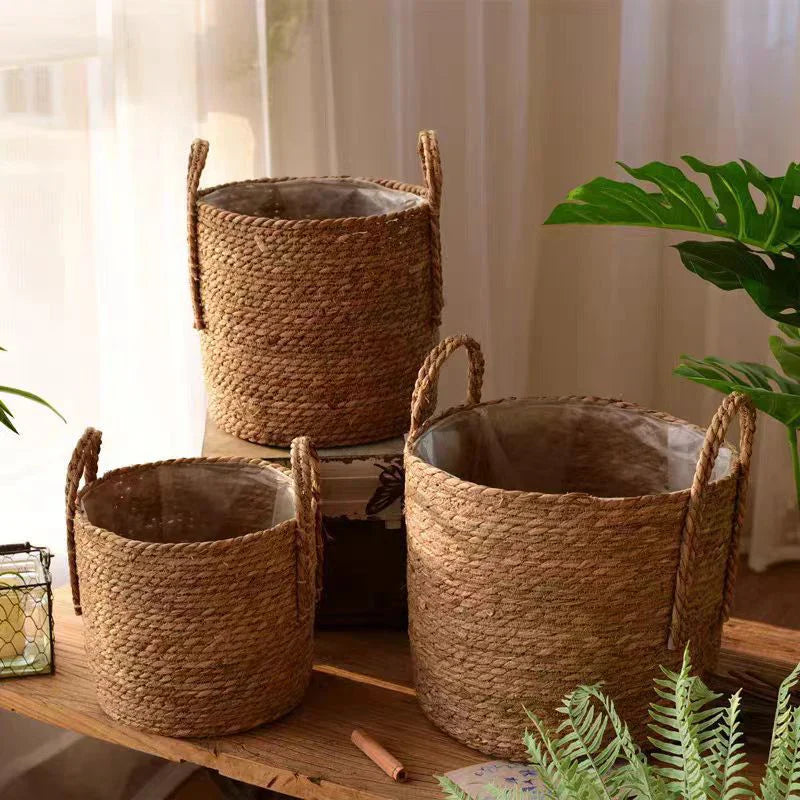 three woven baskets sitting on top of a wooden table