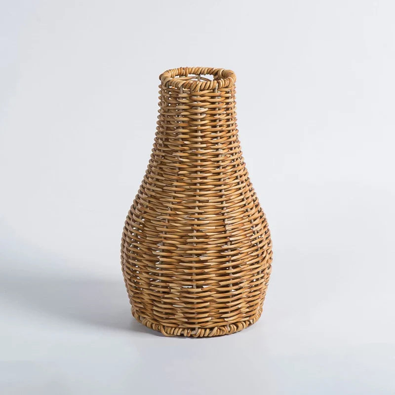 a wicker vase sitting on a white surface