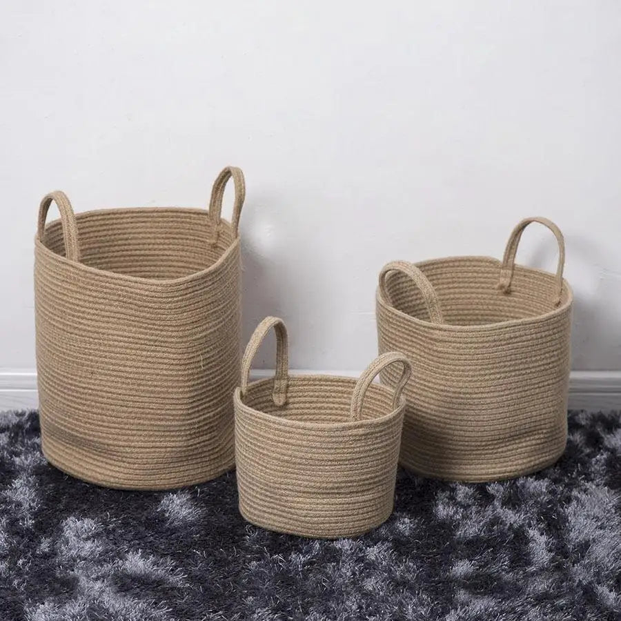 three woven baskets sitting on top of a rug