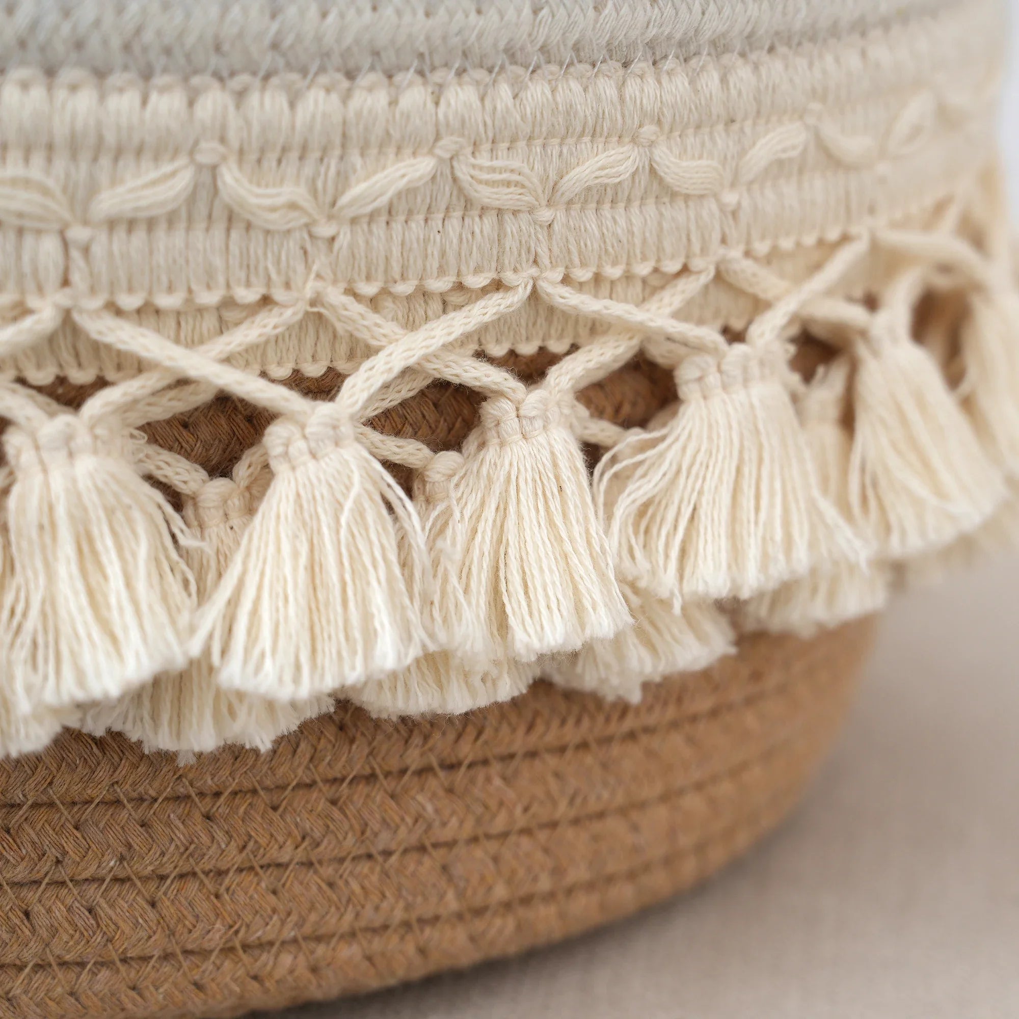 a close up of a hat with tassels on it