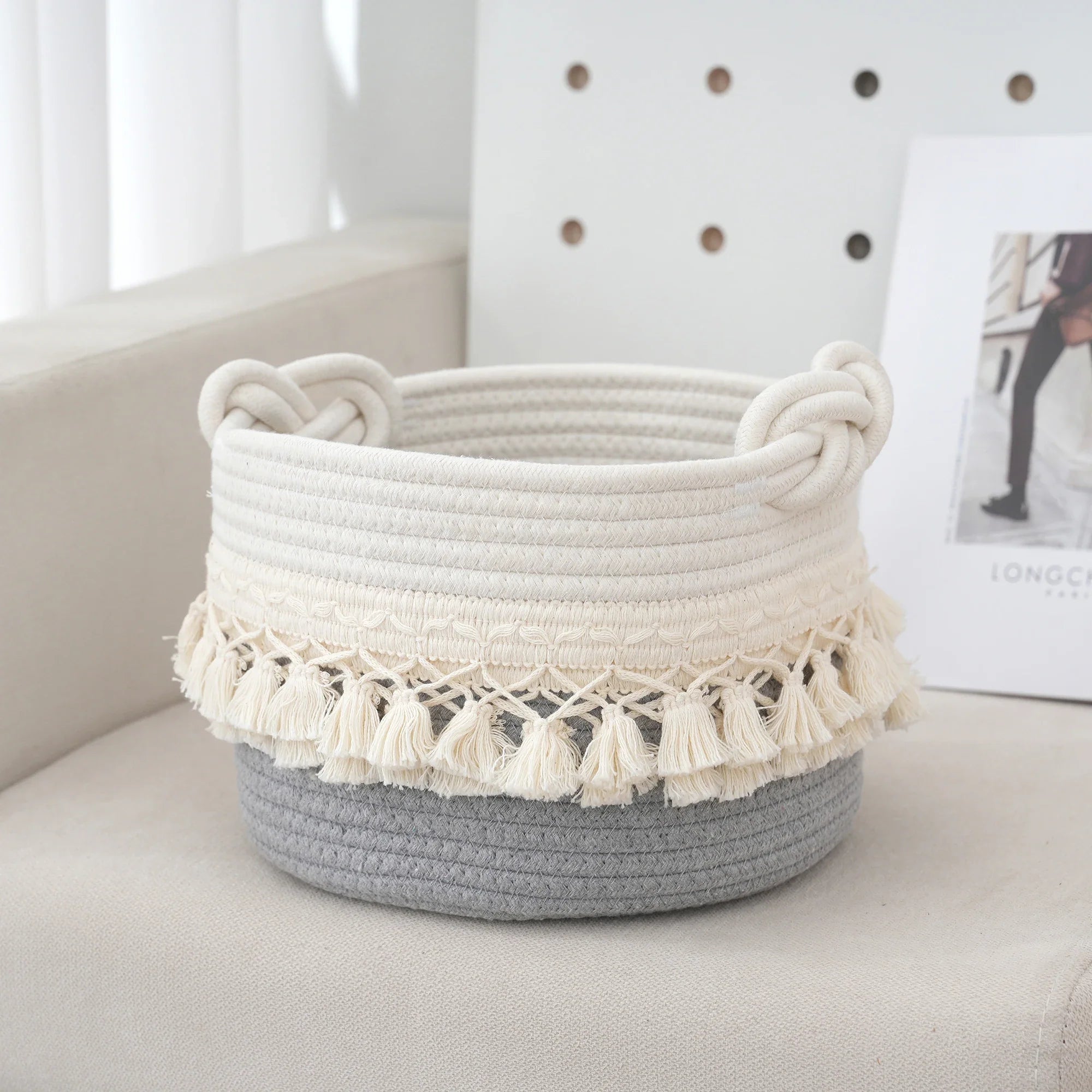 a white and grey basket sitting on top of a chair