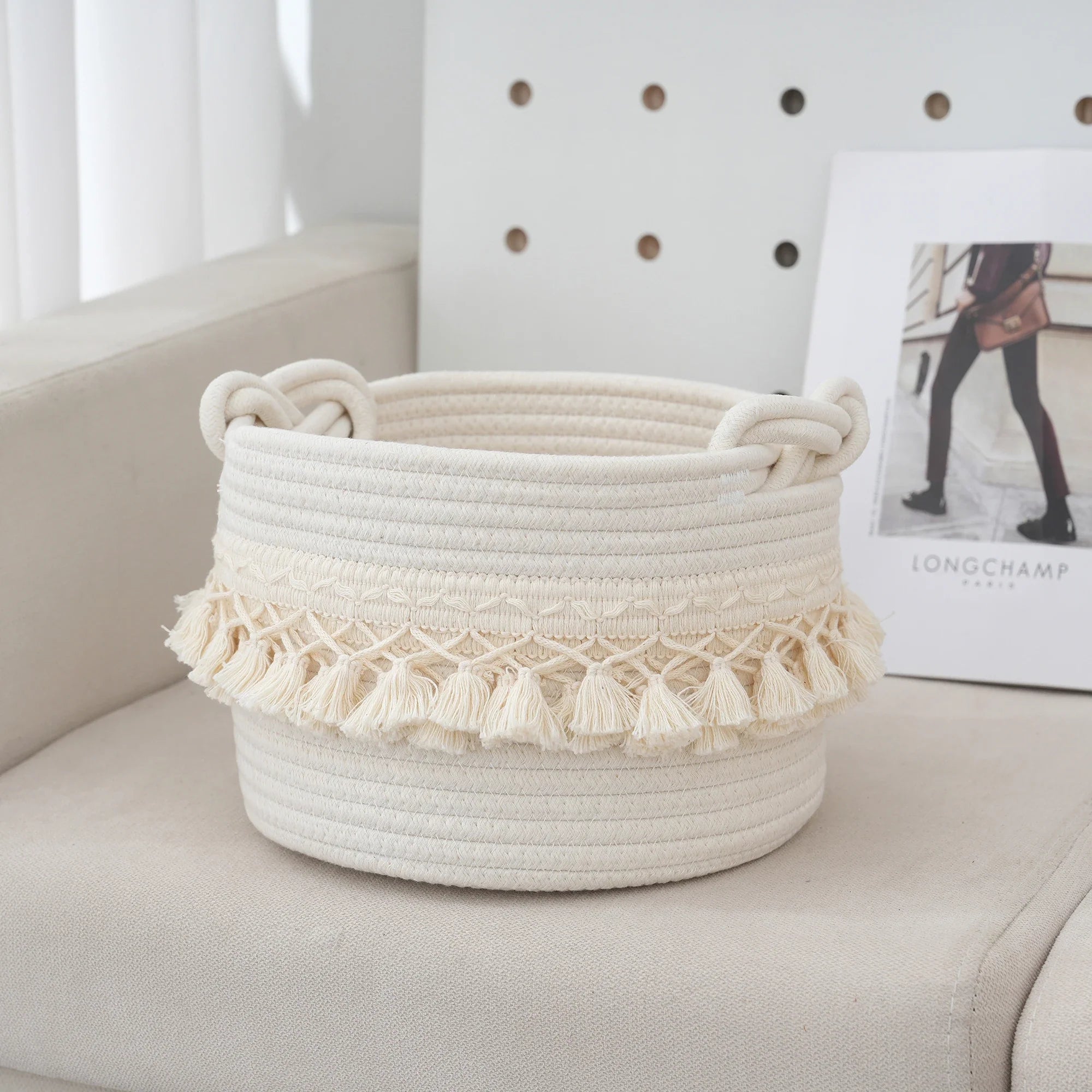 a white basket sitting on top of a couch