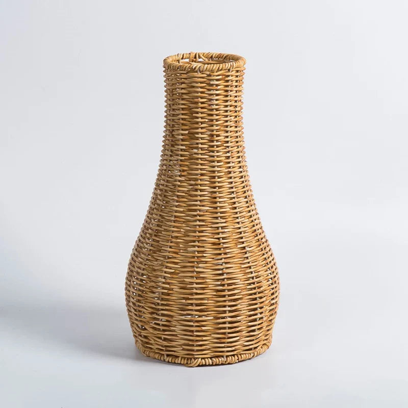 a wicker vase sitting on a white surface