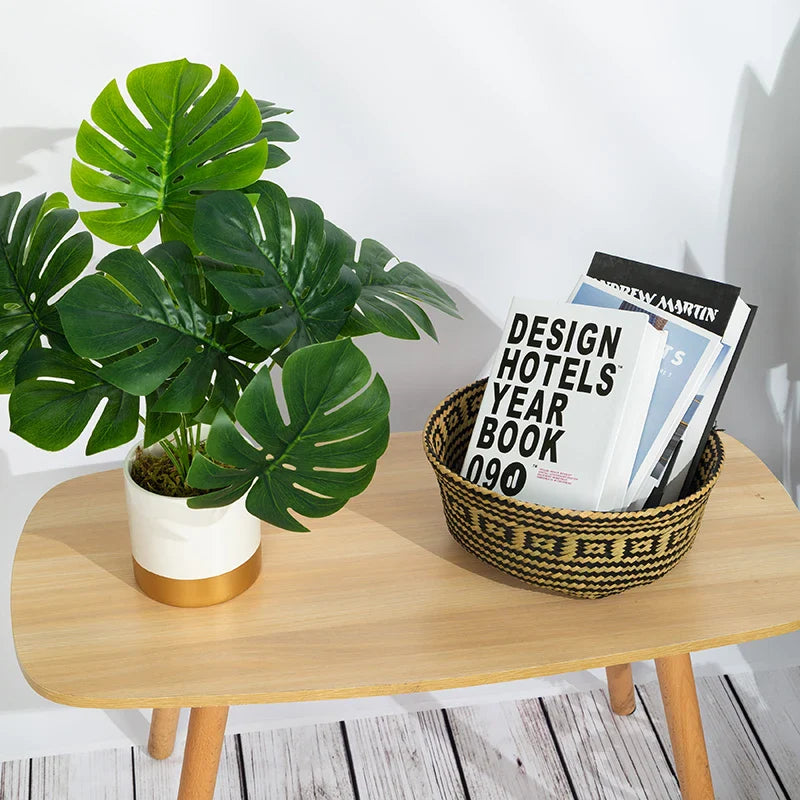 a table with a plant and a book on it