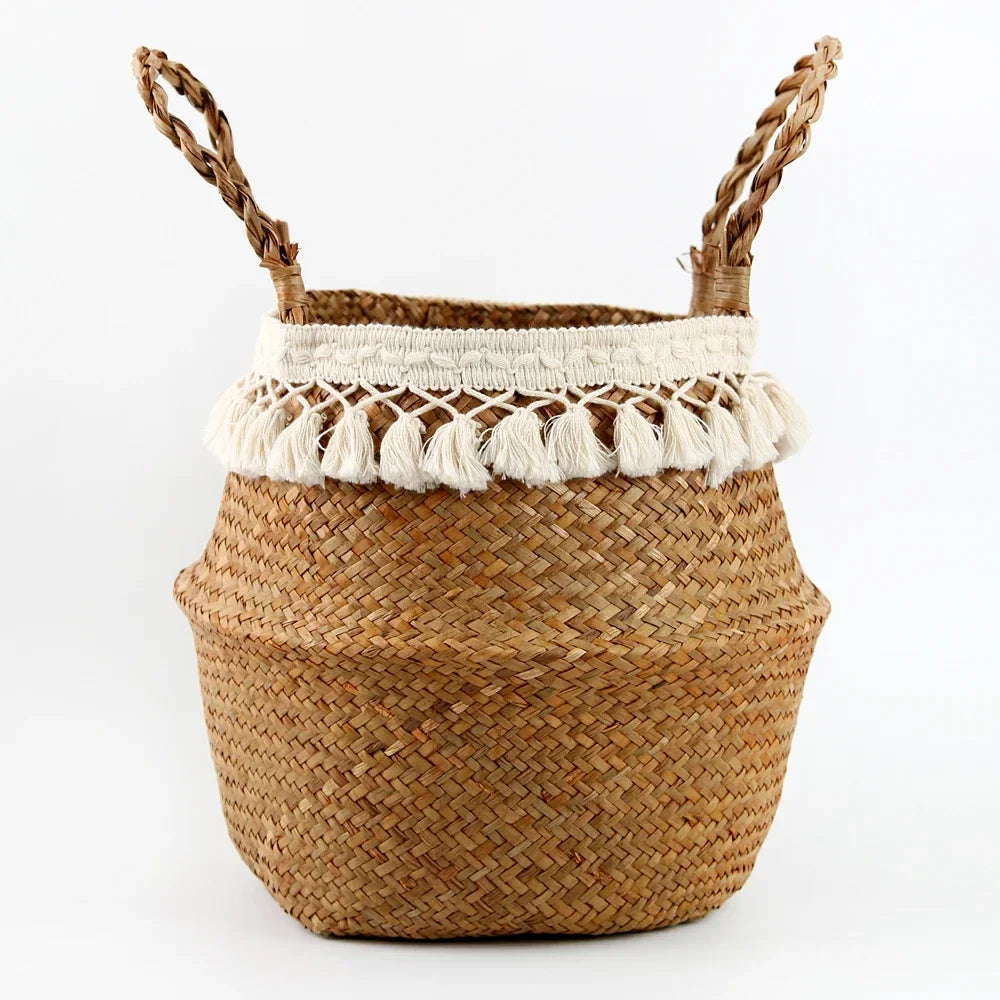 a woven basket with two handles and tassels