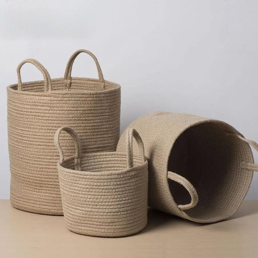 three woven baskets sitting on top of a wooden table