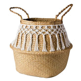 a large woven basket with handles and tassels