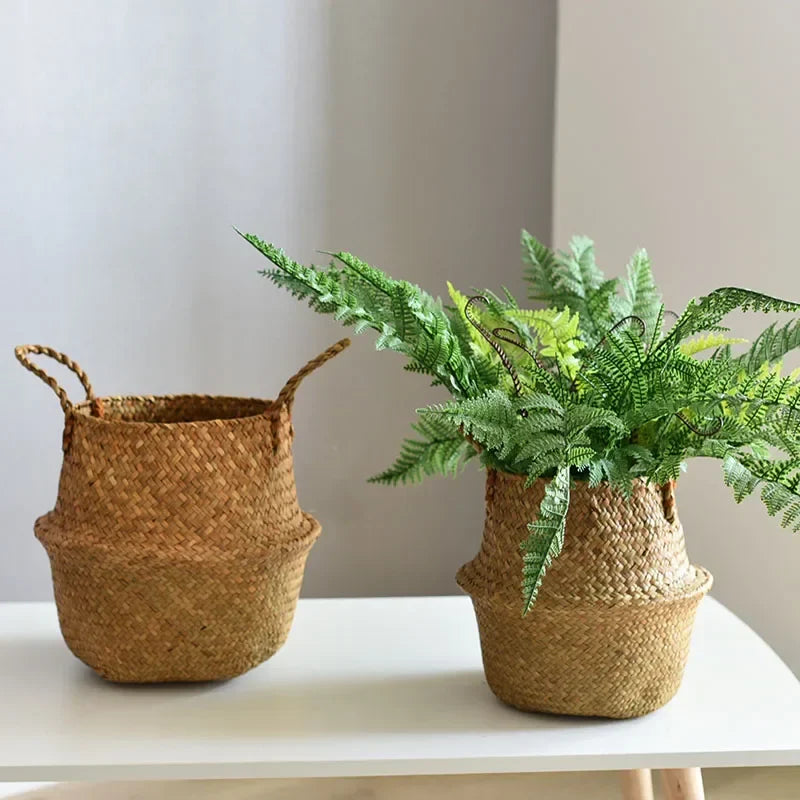 two woven baskets with plants in them on a table