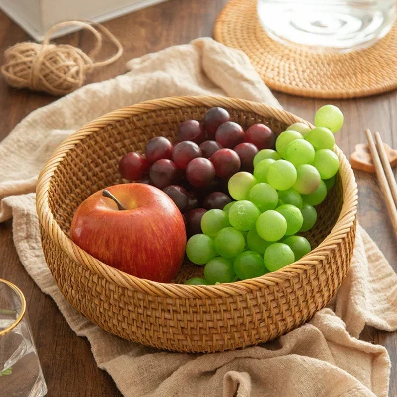 a bowl of grapes, an apple, and an apple on a table