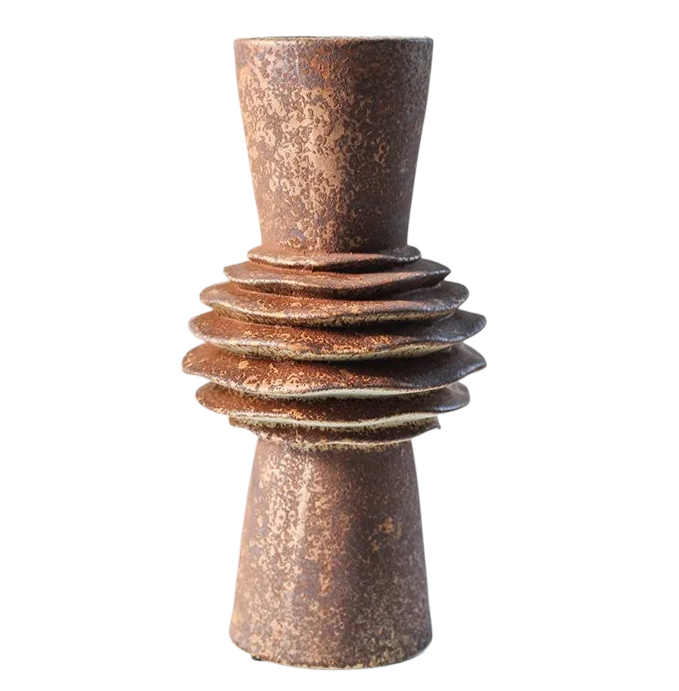 a tall brown vase sitting on top of a black background