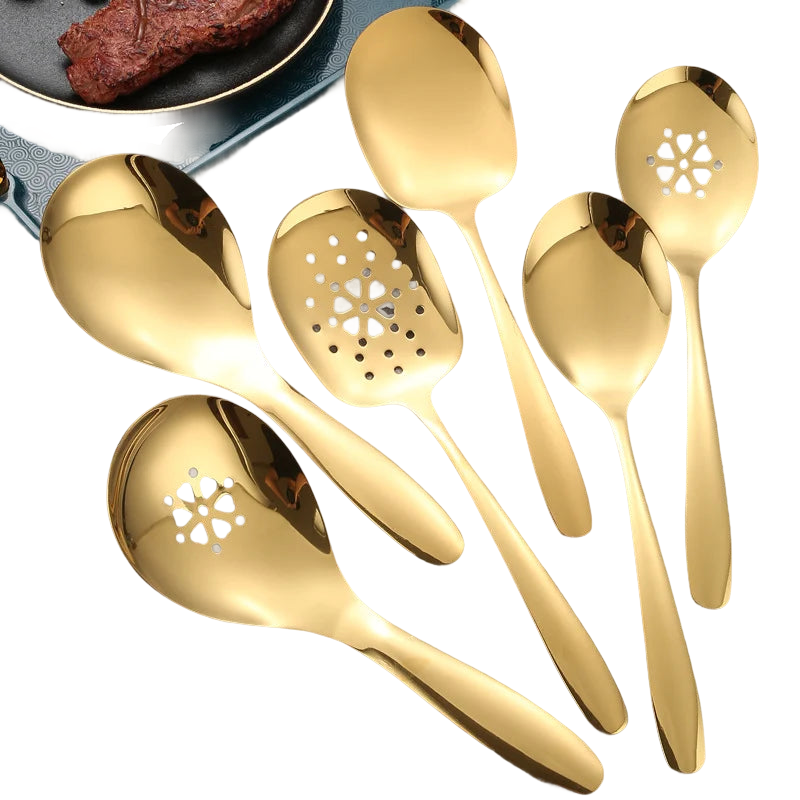 a group of gold colored utensils sitting on top of a table