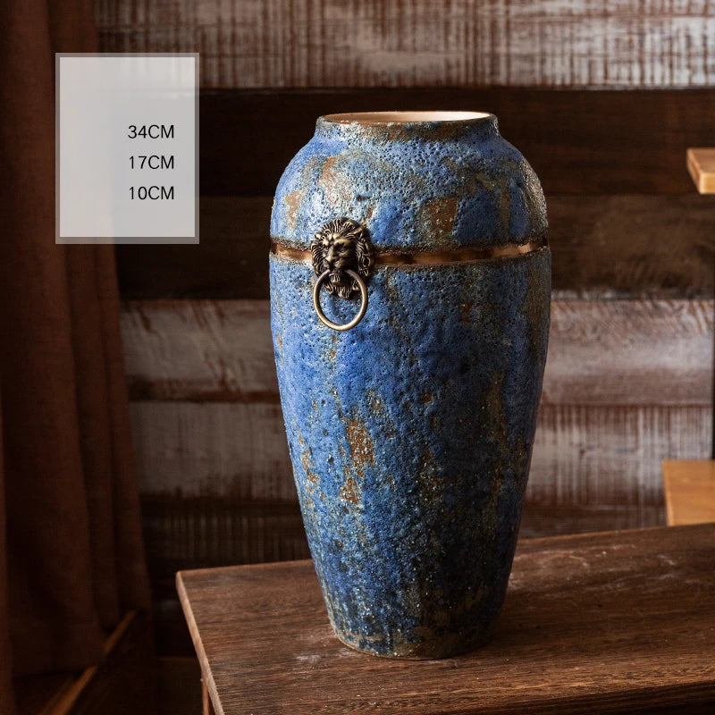 a blue vase sitting on top of a wooden table