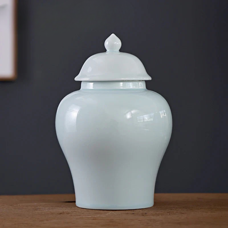 a white vase sitting on top of a wooden table