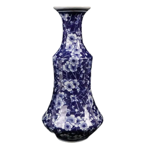 a blue and white vase sitting on top of a table