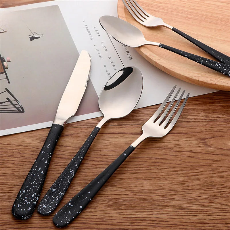 a set of four black and white utensils